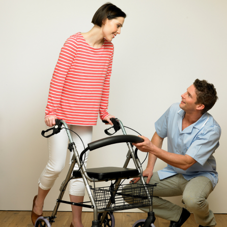 A man helping a woman with a walker